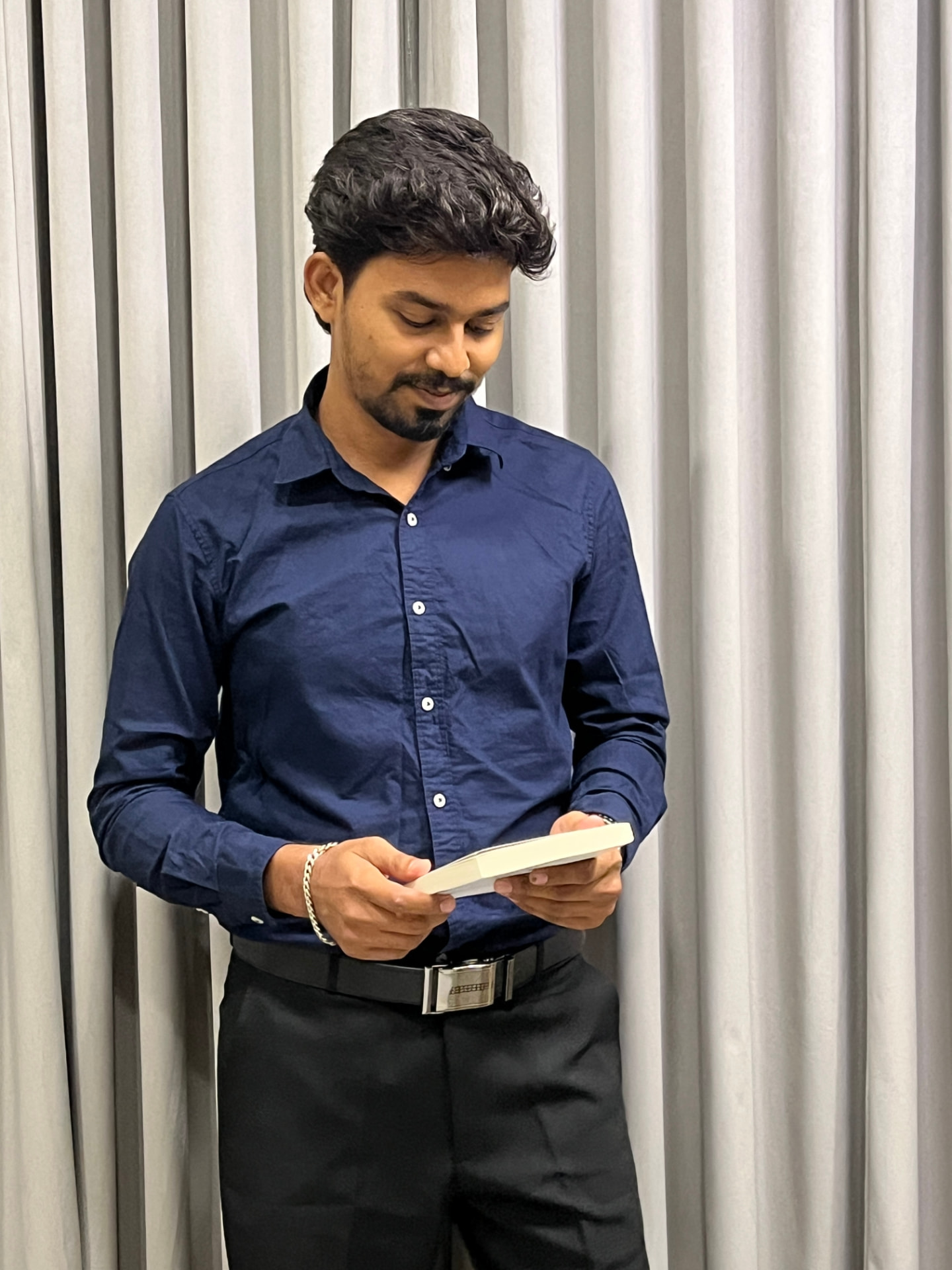 Portrait of Suresh Veerasamy, UX product designer, looking to the side and smiling